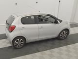 a picture of a small white car parked in a garage