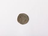 a silver coin on a white surface with a white background