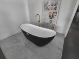 a black and white bathtub sitting in a bathroom