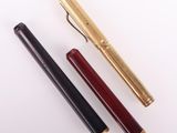 deux stylos et un stylo posés sur une surface blanche