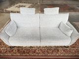 a couch that is sitting on a rug in a room