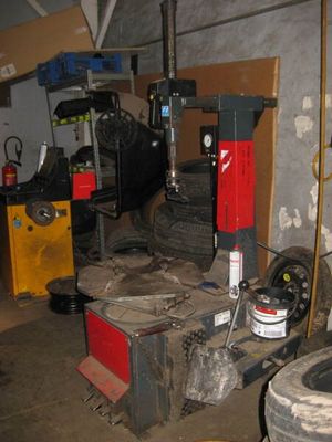 une photo d'un garage rempli de pneus et d'outils