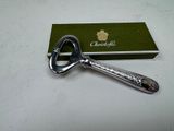 a bottle opener sitting on top of a green box