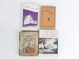 several books are sitting on a white surface next to each other