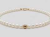 a white pearl bracelet with a gold clasp
