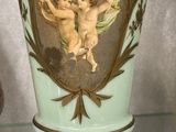 a vase with a picture of two cherensils on it