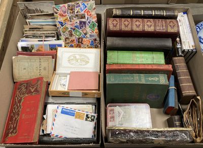 une boîte remplie de livres de toutes sortes posée par terre