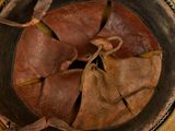 a close up view of a bowl with a leaf inside of it
