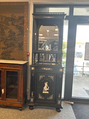 une armoire haute surmontée d'un miroir
