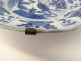 a blue and white plate with a bird on it