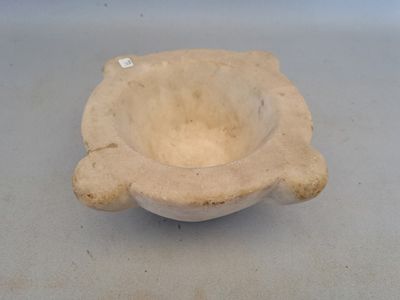 a small bowl sitting on a table with a tag on it