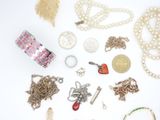 many different types of necklaces and bracelets laid out on a white surface