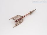 an image of a diamond and ruby arrow broochle