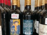 many bottles of wine sitting on a shelf in a store