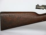 an old wooden rifle with a gun attached to it ' s side