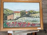une photo d'un tableau représentant une maison, posé sur une étagère