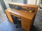 a wooden desk with a computer on top of it