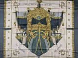a close up of a scarf with a coat of arms on it