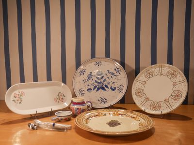 three plates and a bowl on a wooden table