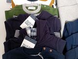 a lot of men ' s clothing on display on a table