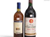two bottles of wine sitting next to each other on a white surface