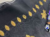 a black and gold scarf with a butterfly design on it