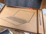 a cardboard box with a laptop inside of it