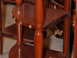 a small table with a shelf on it in a room