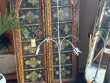 a tall cabinet with a mirror and a pair of skis