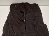 pair of brown pants sitting on top of a white shelf