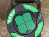 a close up of a green and black hose on top of a floor