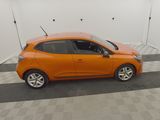 an orange car is parked in a room with a checkered floor