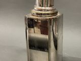 a silver bottle that is sitting on a table