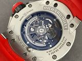 a close up of a wrist watch with a red strap