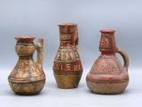 three vases sitting next to each other on a white surface