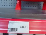 a red object on the shelf in the store