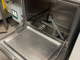 an open oven with a metal pan inside of it