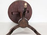 a small wooden table with a metal stand on it
