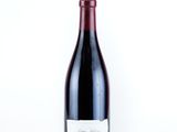a bottle of wine sitting on top of a white table