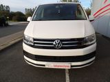 the front end of a white van parked in a parking lot