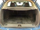 the back of a blue car with the trunk open and the back seats down