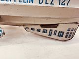 a close up of a toy airplane on a white surface