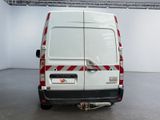 a white van with red stripes parked in a room