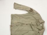 the jacket is tan and has a brown patch on it