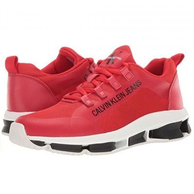 a red sneaker with a black and white logo on the side