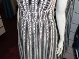 a mannequin wearing a dress on display in a clothing store