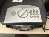 a picture of a remote control on a shelf