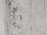 a clear glass vase with a design on it