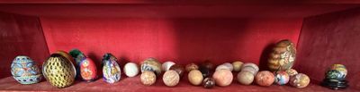 many different vases on a shelf in a red room
