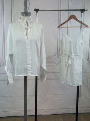 two dresses on display on a stand in a room